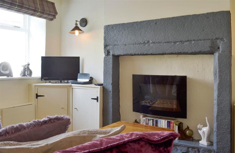 Welcoming living room with feature fireplace at Cosy Nook in Cromford, near Matlock, Derbyshire, England