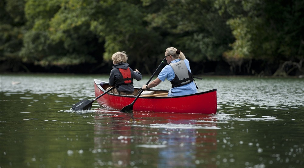 Canadian canoes on Pont Pill in the Fowey estuary, Cornwall. at Cotehele Engine Cottage in Calstock, Cornwall