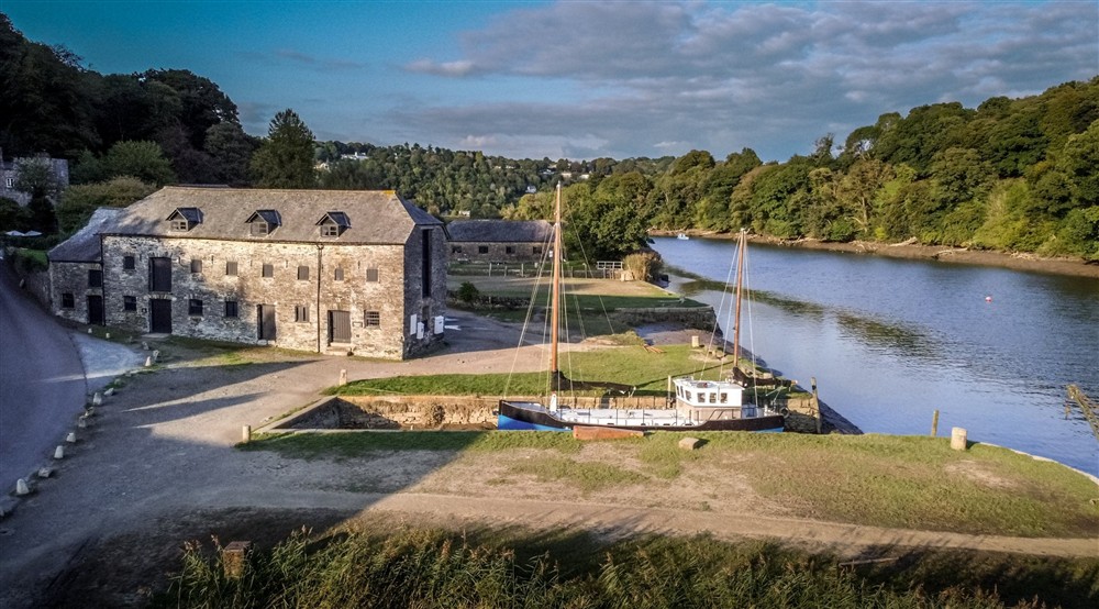 View of the quay and river with boat moored up (photo 2) at Cotehele Engine Cottage in Calstock, Cornwall