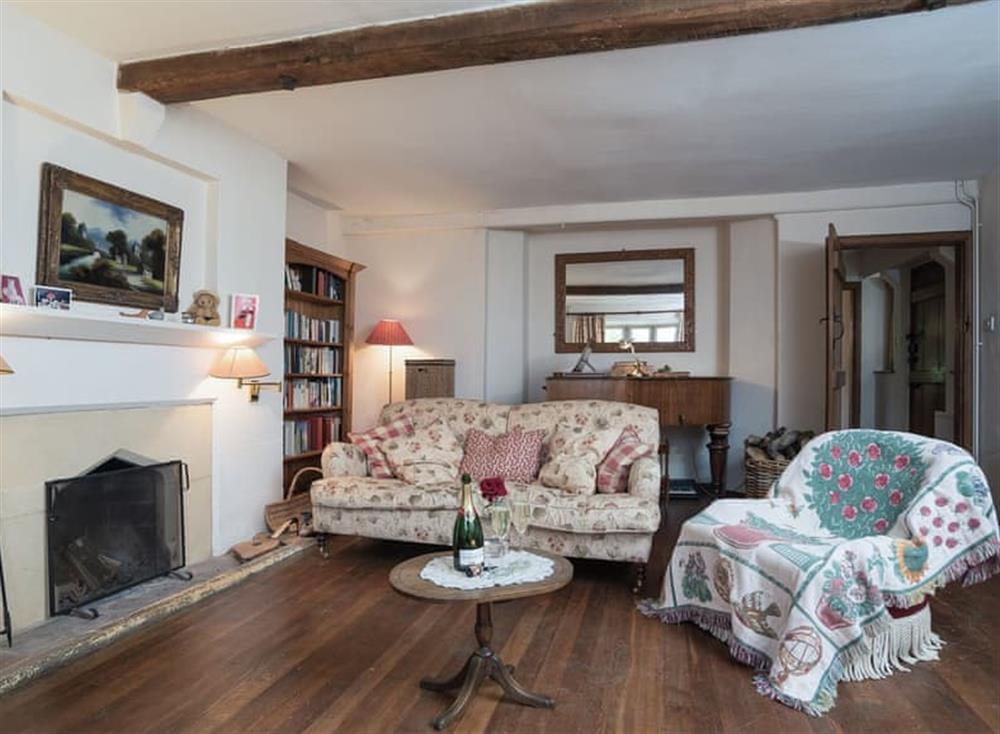 Living room with open fire, Freeview TV, grand piano, beams and wooden floor (photo 3) at Cotswold Way Cottage in Wood Stanway, near Winchcombe, Gloucestershire