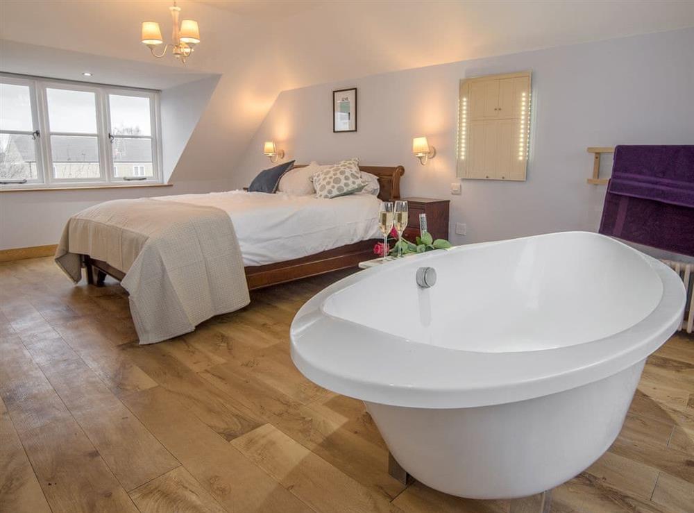 Attractive double bedroom with a freestanding bath at Cotswolds Country House in Kingham, near Chipping Norton, Oxfordshire