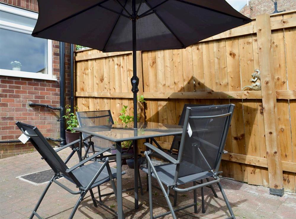 Enclosed courtyard with garden furniture at Cottage on the Green in Acomb, near York, North Yorkshire