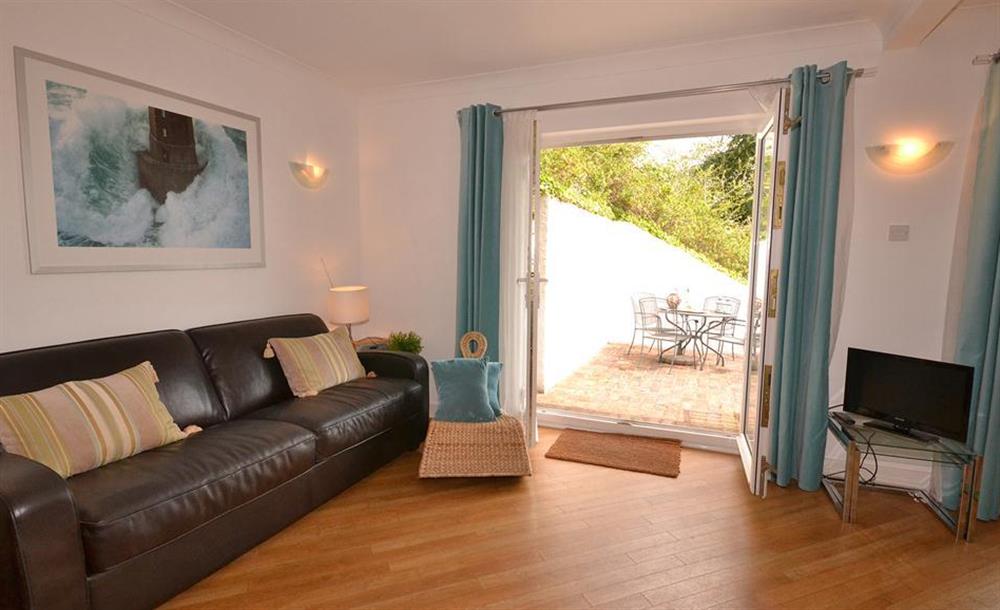 A comfortable sofa in the kitchen diner and doors to lower terrace at Cotterbury, Dartmouth