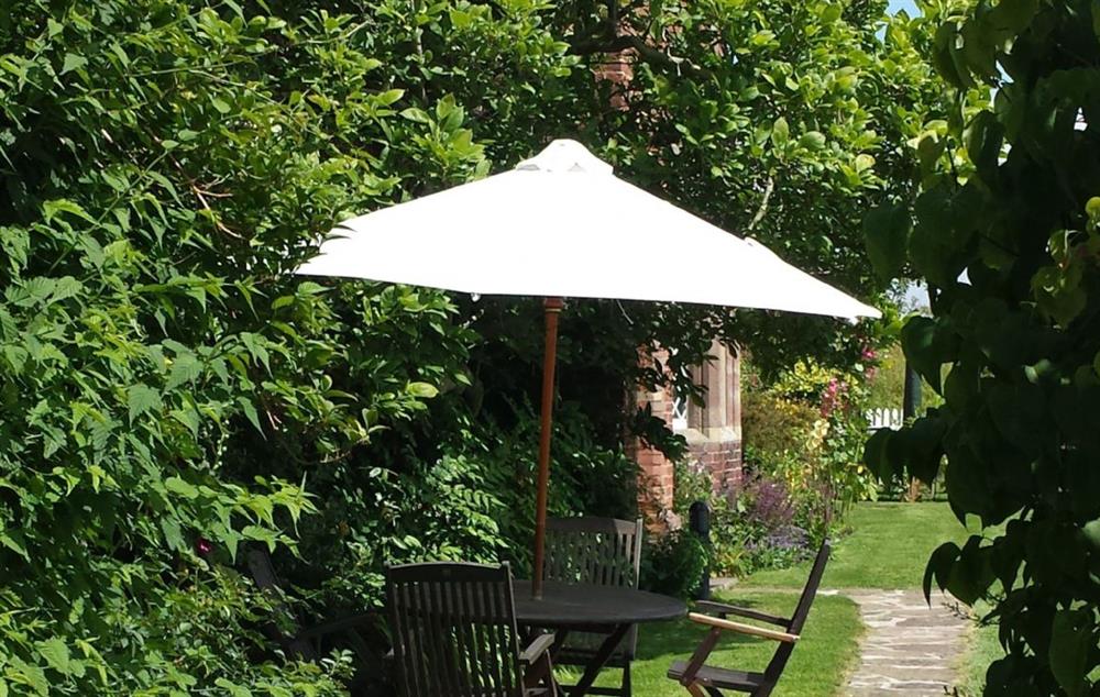 Beautiful outside space with garden furniture and seating for four guests at Cotton Cottage, Whitchurch