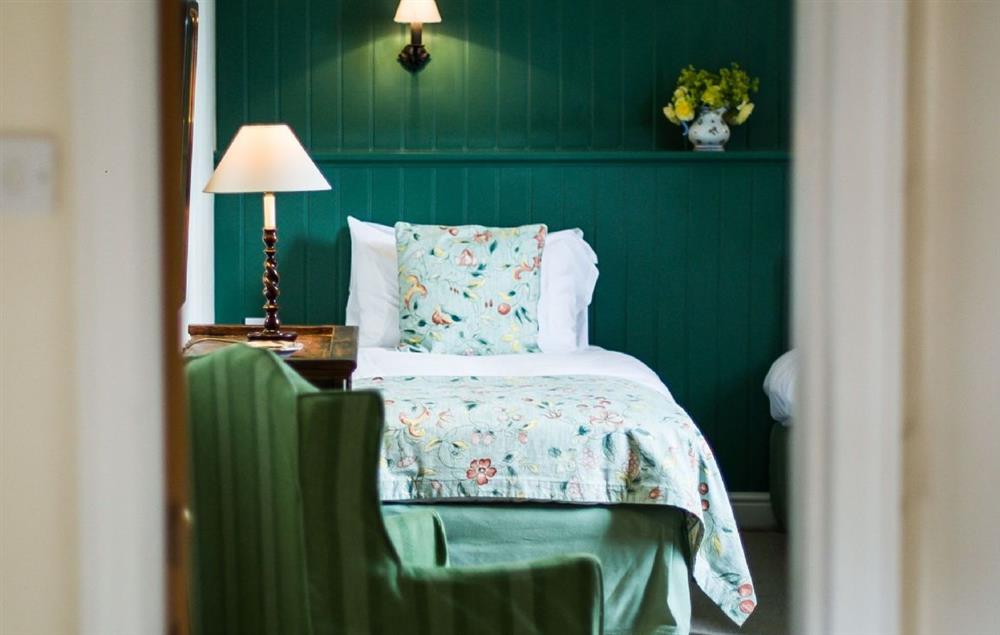 Calming colours of green and cream in the twin bedroom at Cotton Cottage, Whitchurch
