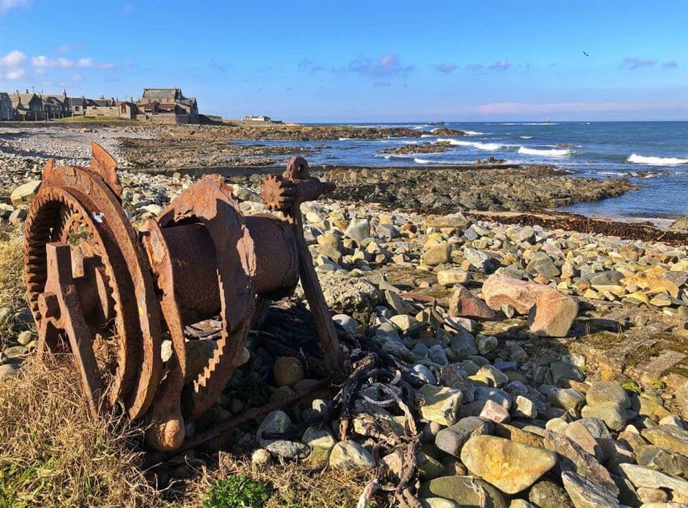 Cairnbulg beach with old winch used to pull old boats up the shore. with the Beacon and the Sovereign in the back ground at Cotton Shore in Inverallochy, near Fraserburgh, Aberdeenshire