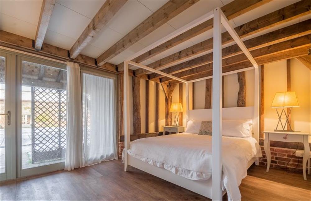 Four poster bedroom with french doors leading outside (photo 2) at Court Barn, Stoke By Nayland