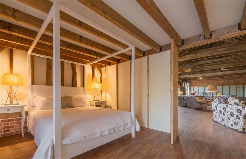 Four poster bedroom with french doors leading outside at Court Barn, Stoke By Nayland