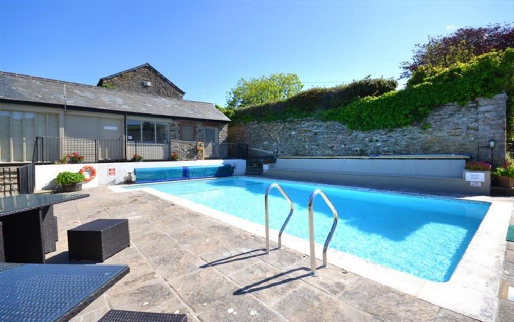 The outdoor, heated swimming pool. at Court Barton Cottage No. 1 in South Huish