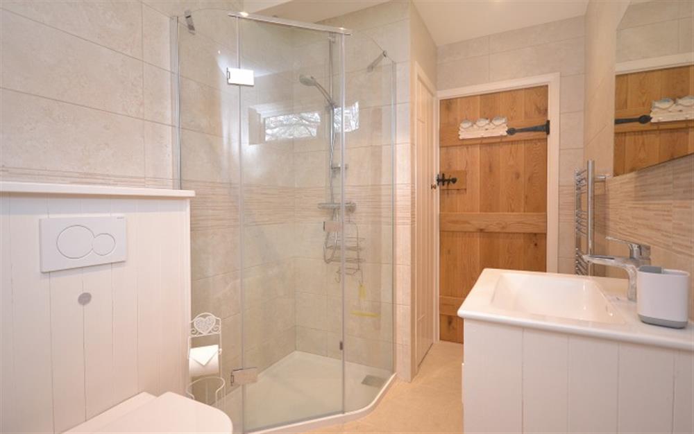 The family bathroom with bath and separate shower cubicle at Court Barton Cottage No. 2 in South Huish