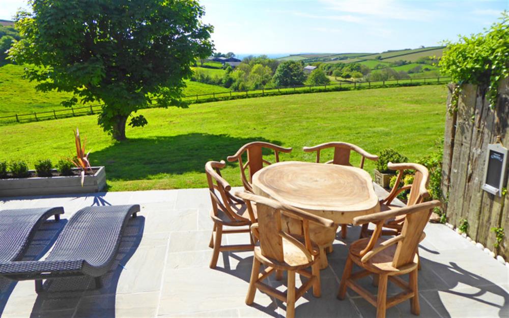 The patio with stunning views at Court Barton Cottage No. 2 in South Huish