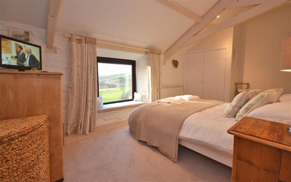 The master bedroom with picture window looking down to the sea. at Court Barton Cottage No. 7 in South Huish