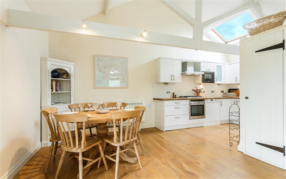 The dining area showing kitchen at Court Barton in South Huish