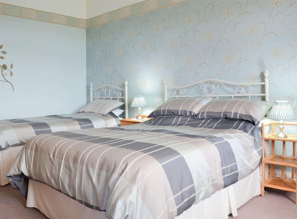 Comfortable bedroom with double and single beds at Court Place in Porlock, Somerset