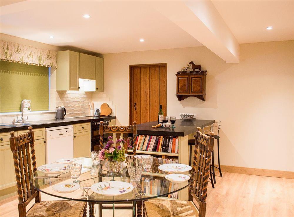 Contemporary dining table next to the kitchen area at Courtside in Fairfield, near Appledore, Kent