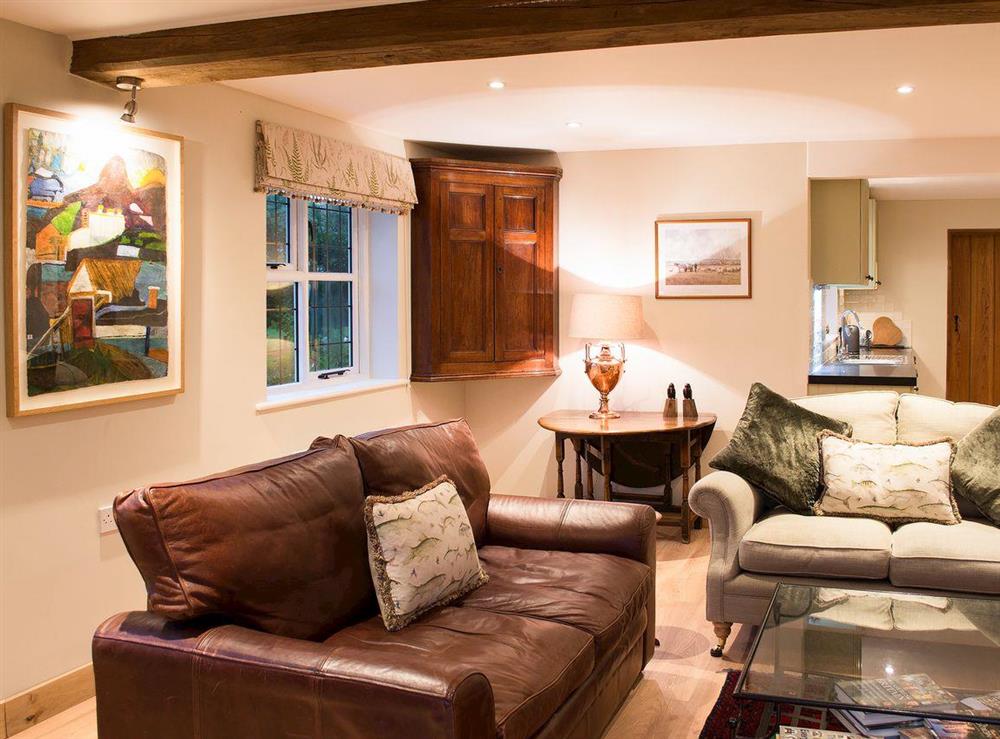 Leather sofa and antique furniture in the living area at Courtside in Fairfield, near Appledore, Kent