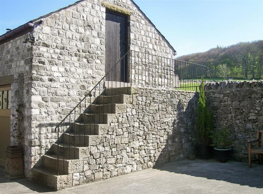Stone steps to sitting out area at Courtyard Cottage at Dam Hall Barn in Peak Forest, near Buxton, Derbyshire
