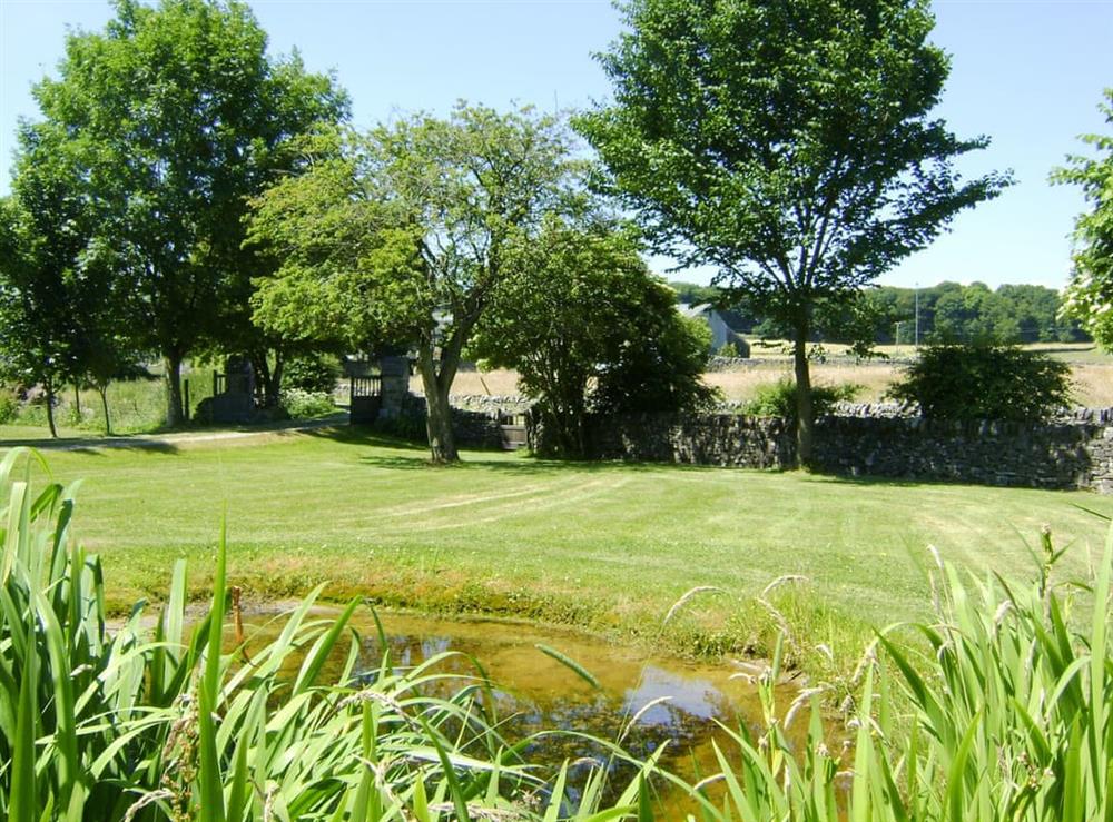 Well-maintained garden areas at Courtyard Cottage at Dam Hall Barn in Peak Forest, near Buxton, Derbyshire