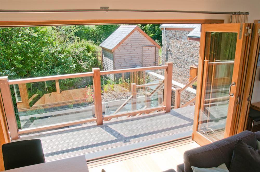 Bi-folding doors out to private terrace (via steps) at Courtyard Cottage in , Dartmouth