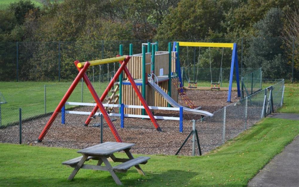 Your little ones will love the children's play area. To the left of the photo, you'll find a large grassed area; perfect for a game of football. at Cove 1 in Maenporth