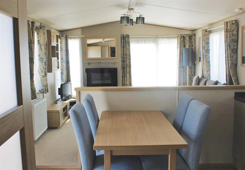 Living area and dining area at a Brightstone at Cove Holiday Park in Portland, Weymouth