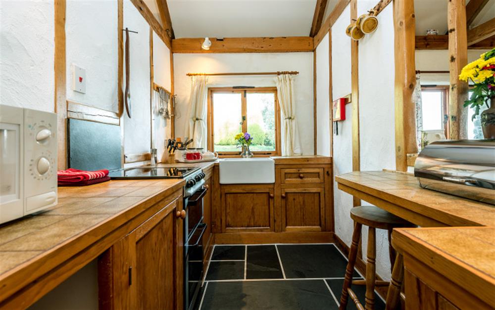 The rustic charm carries on through to the well-equipped kitchen. at Cove View in Porthallow