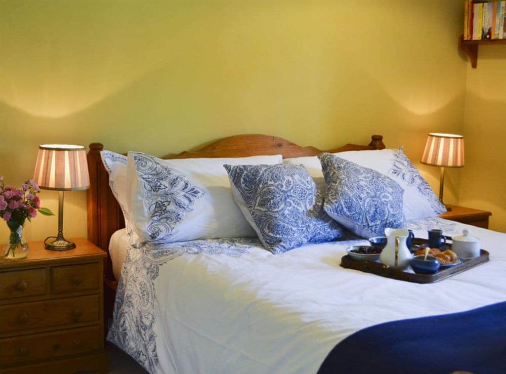 Comfortable bedroom with kingsize bed at Cowbeech Farm Cottage in Cowbeech, near Hailsham, East Sussex