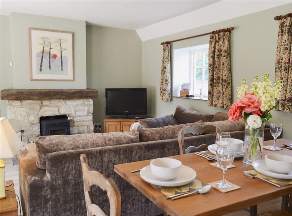 Cosy living and dining room with wood burner at Cowbeech Farm Cottage in Cowbeech, near Hailsham, East Sussex