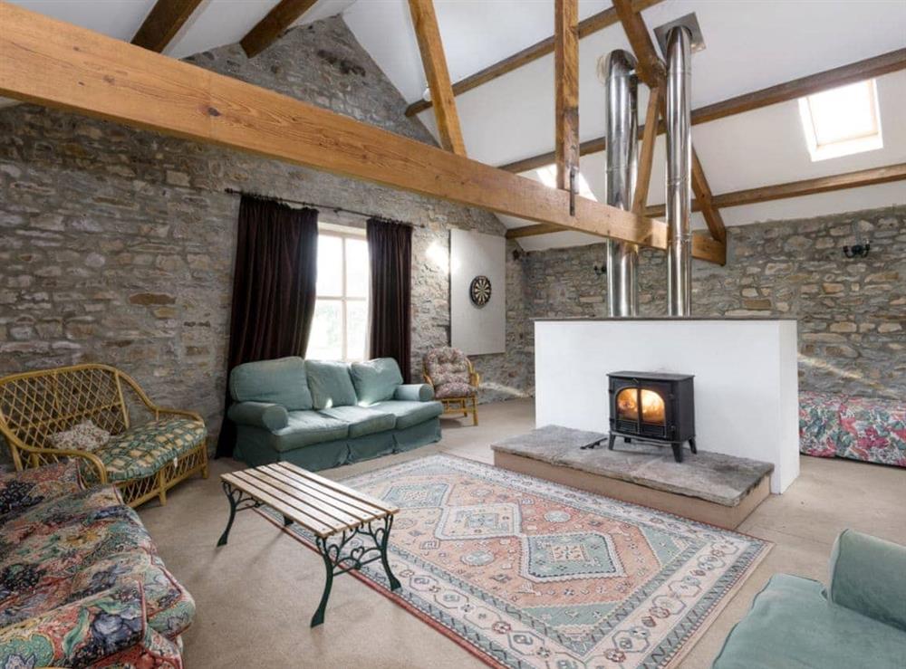 Spacious seating area with wood burner within recreation room at Cowdber Barn in Burrow, Kirkby Lonsdale, Cumbria., Lancashire
