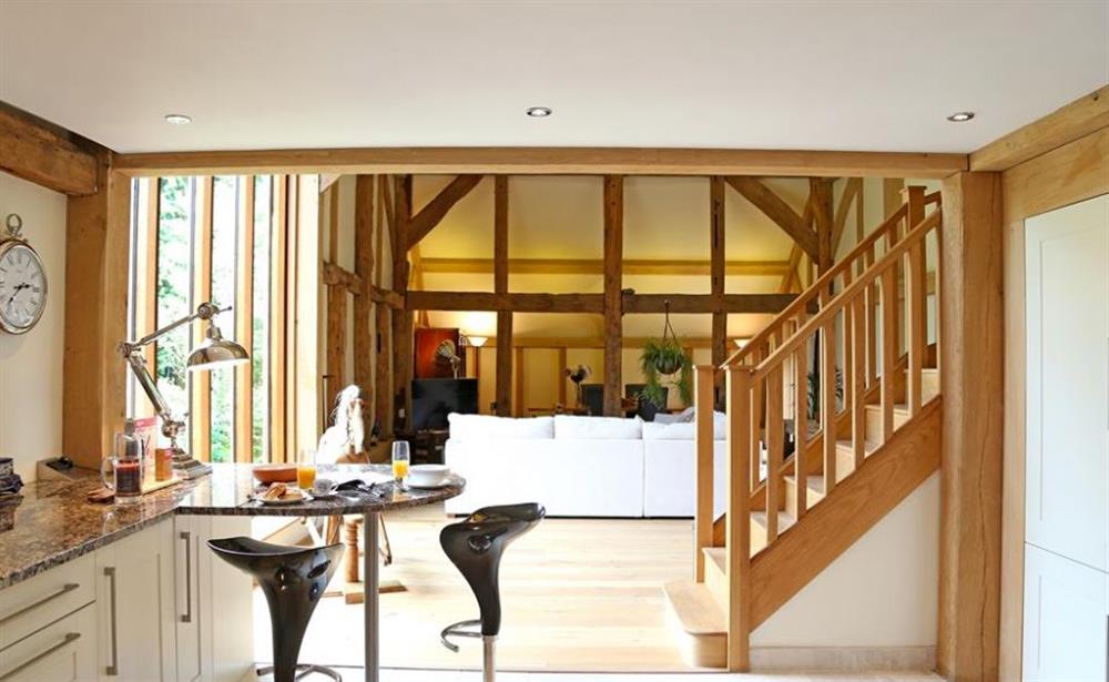 Living room and stairs at Cowshot Barn, Brookwood, Surrey