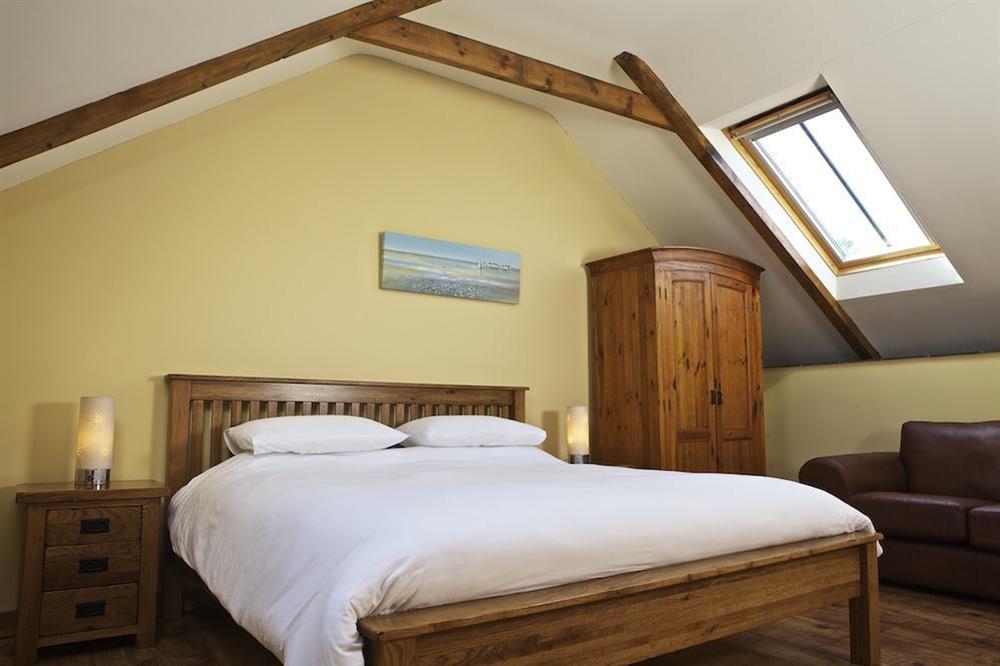 Spacious master bedroom with super-King size bed and en suite bathroom at Cowslip Cottage in Frogmore, Nr Kingsbridge