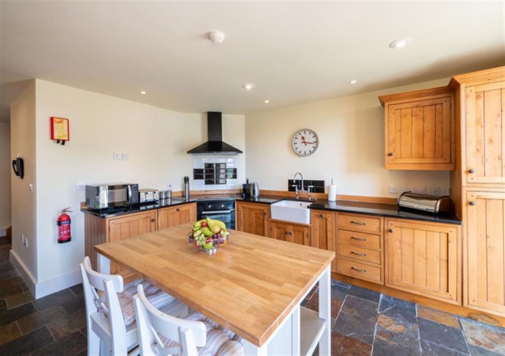 Large country style kitchen with bar stool seating at Cox Tor in Chagford