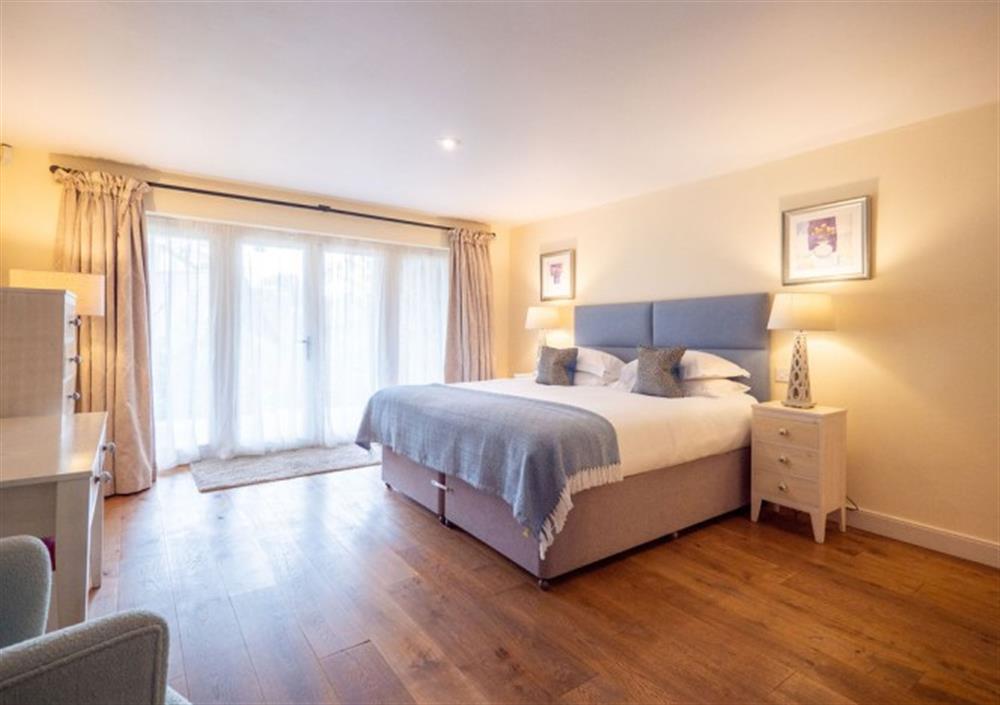 Spacious Bedroom 2 with double doors to decked terrace at Cox Tor in Chagford