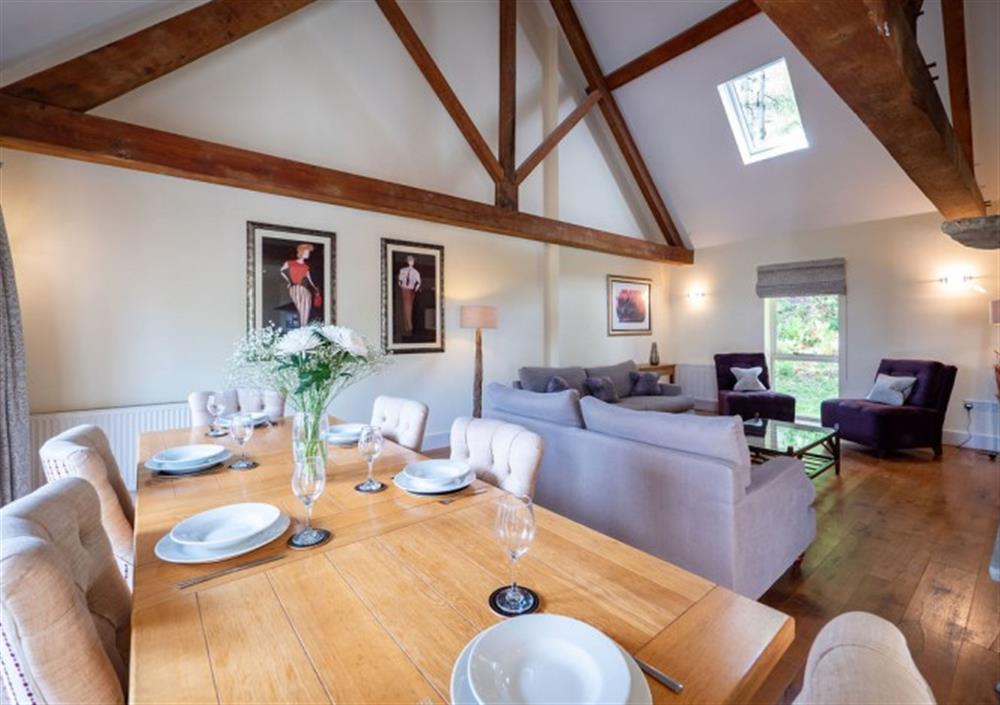 Spacious dining and sitting areas with high vaulted ceilings and exposed beams at Cox Tor in Chagford