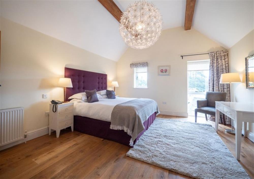 Top floor Bedroom 1 with high ceilings and large windows at Cox Tor in Chagford