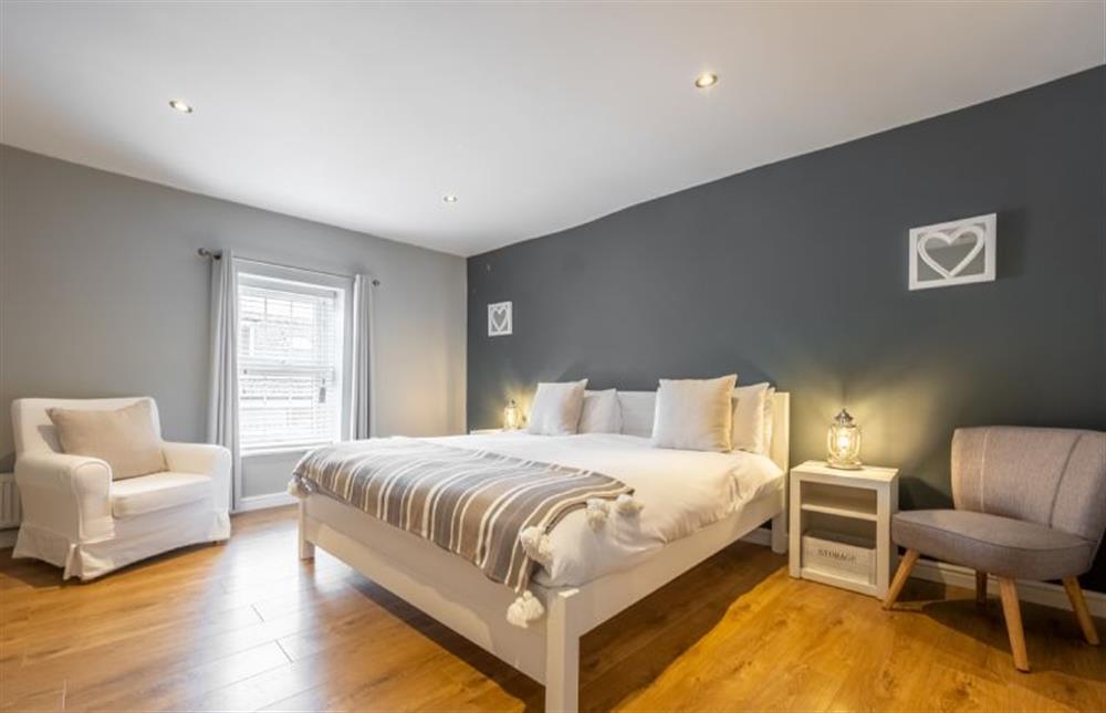 First floor: Master bedroom with a super-king size bed at Coxswains House, Wells-next-the-Sea