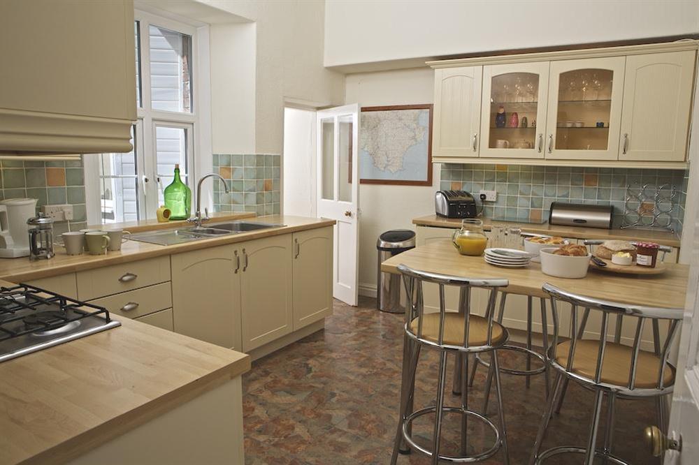 Well equipped kitchen with breakfast bar (photo 2) at Coxswains Watch in 59 Fore Street, Salcombe