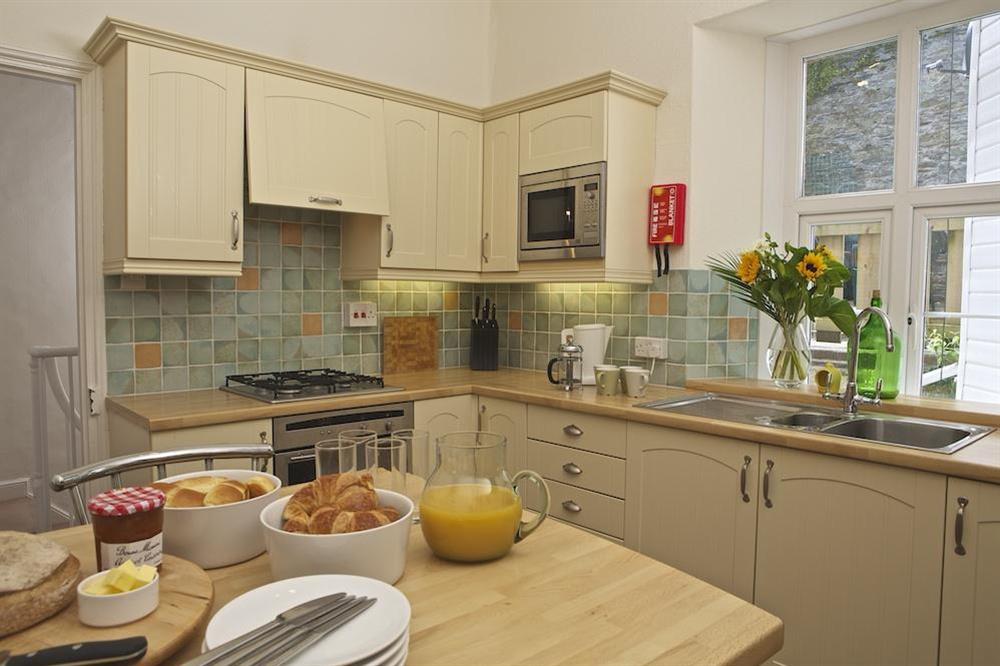 Well equipped kitchen with breakfast bar at Coxswains Watch in 59 Fore Street, Salcombe