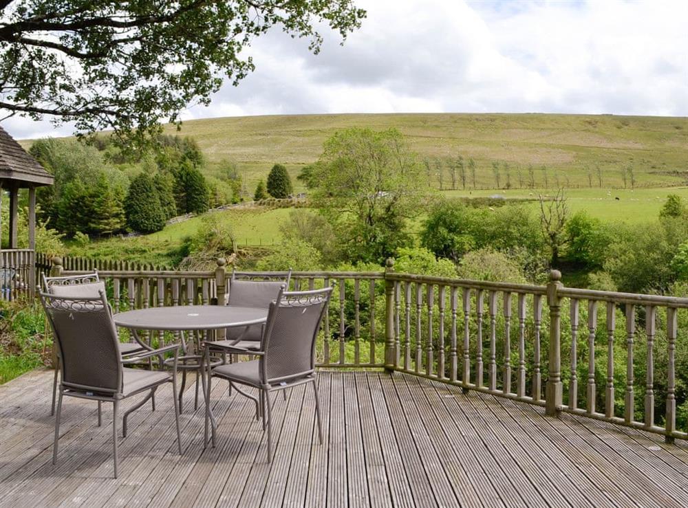 Decked area with outdoor furniture at Barn Cottage, 