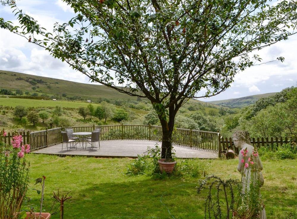 Well-maintained garden with decked patio area at Barn Cottage, 