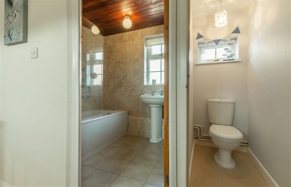 First floor: Family bathroom with bath, overhead shower, wash basin and heated towel rail and separate WC