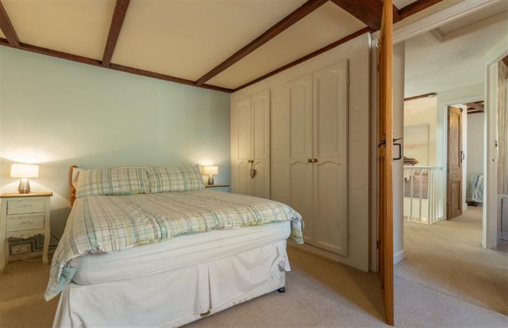 First floor: Master bedroom with double bed at Crabpot Cottage, East Runton near Cromer