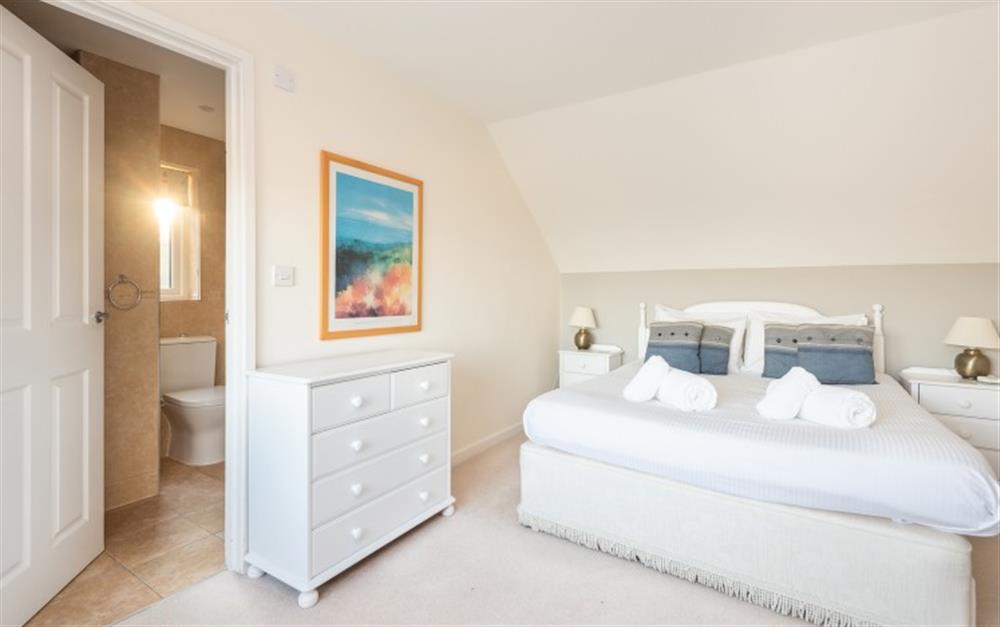 The bed in the master bedroom is kingsize. at Crags 26 Bay View Cottage in Maenporth