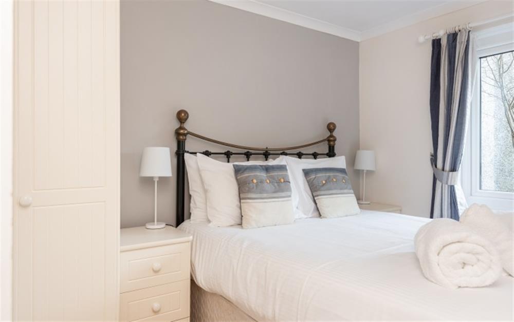 The grey feature wall in the second bedroom compliments the neutral colour scheme. at Crags 26 Bay View Cottage in Maenporth