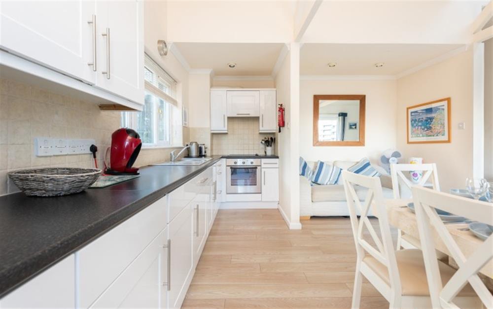 The long galley kitchen is fully equipped with integrated full size appliances at Crags 26 Bay View Cottage in Maenporth