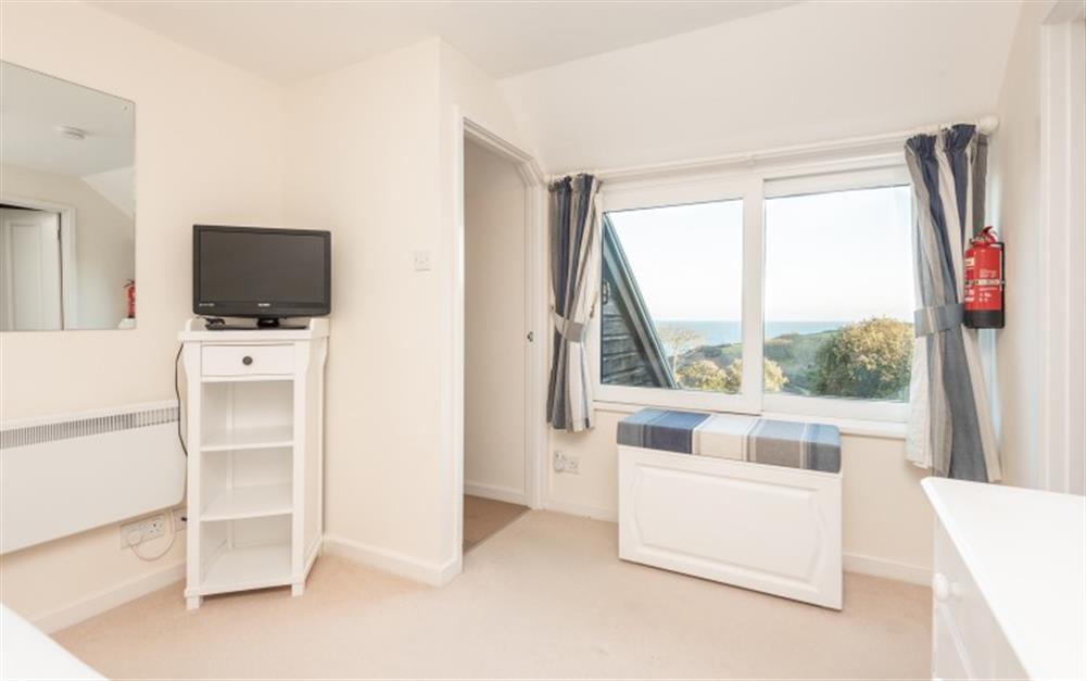 The master bedroom has sea views at Crags 26 Bay View Cottage in Maenporth