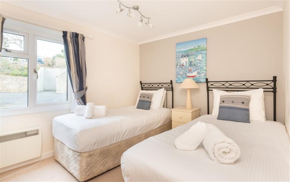 The third bedroom has twin beds and is on the ground floor opposite the shower room at Crags 26 Bay View Cottage in Maenporth