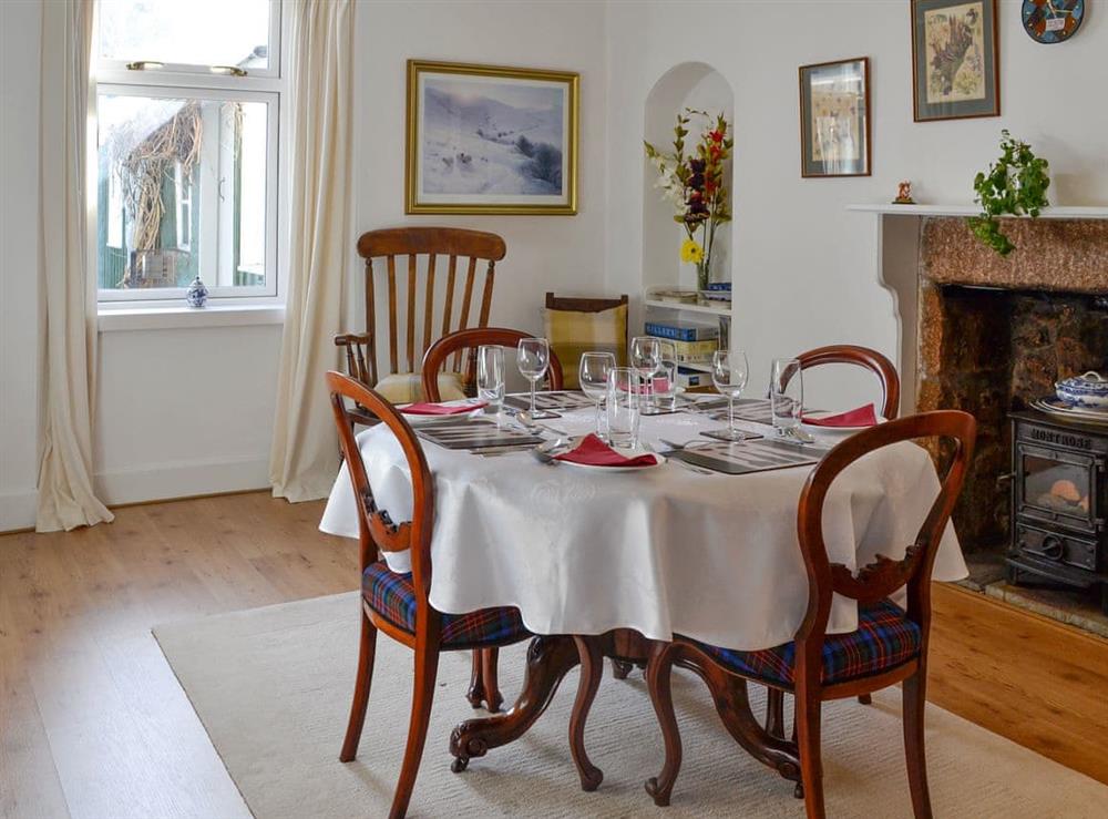 Elegant dining room with ornamental woodburner and traditional furniture at Craigclunie in Ballater, Aberdeenshire