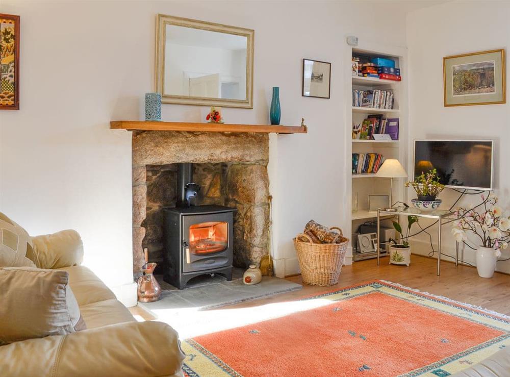Warm and welcoming living room with open fireplace at Craigclunie in Ballater, Aberdeenshire