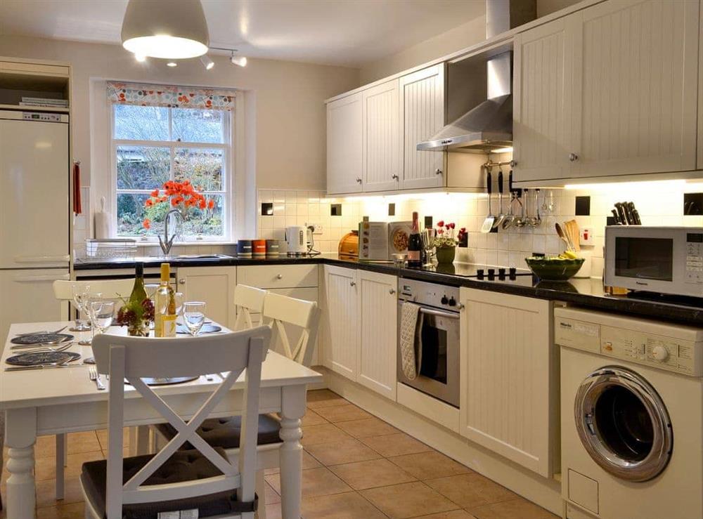 Well equipped kitchen with stylish dining area at Craigellie Cottage in Alyth, Perthshire